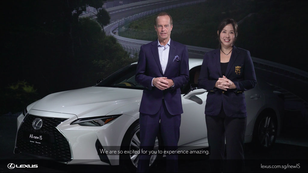 Two hosts in front of the new Lexus IS during the official car launch live stream