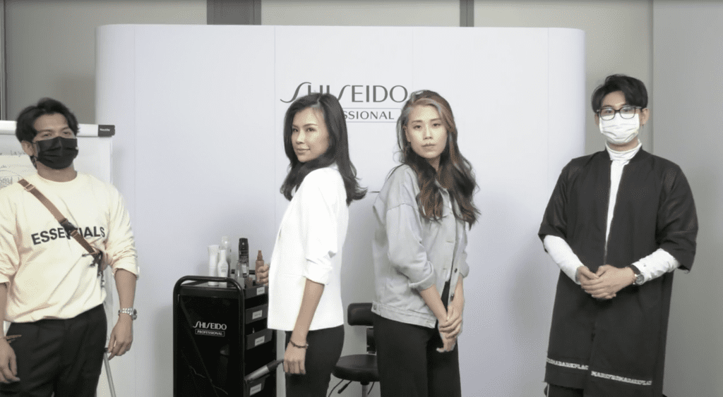 Shiseido hair artists standing next to their models who are posing for the camera