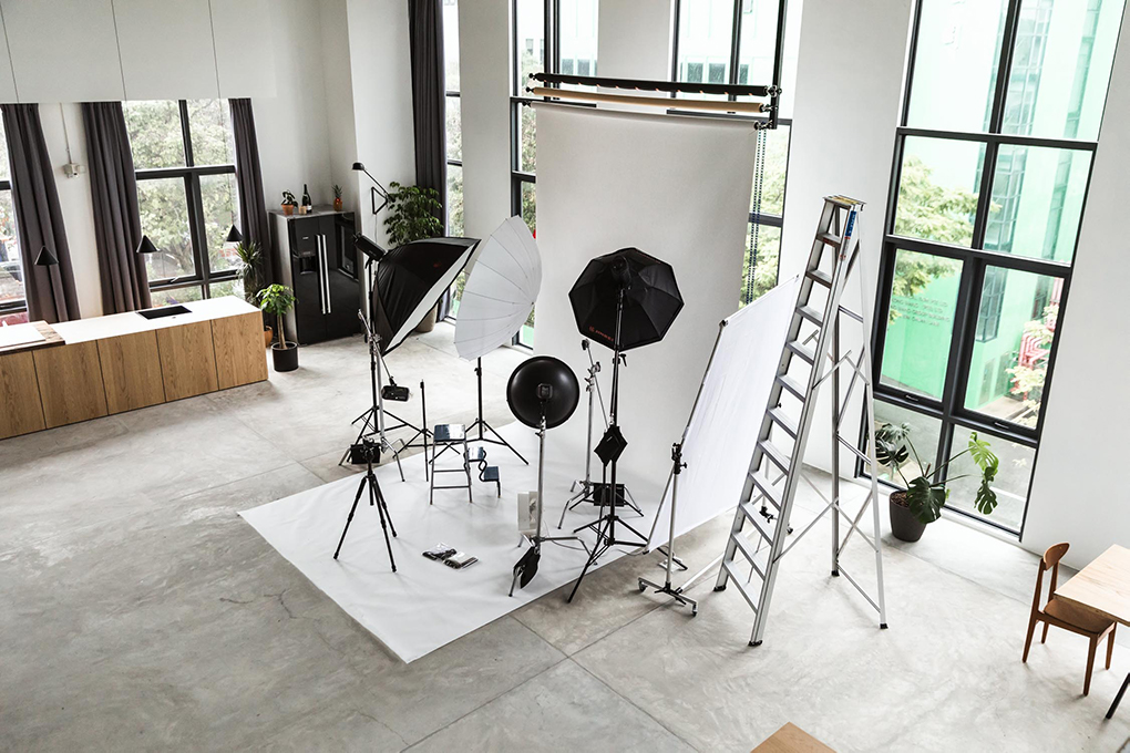 A Studio With White Backdrop, Softbox Lights & A Ladder