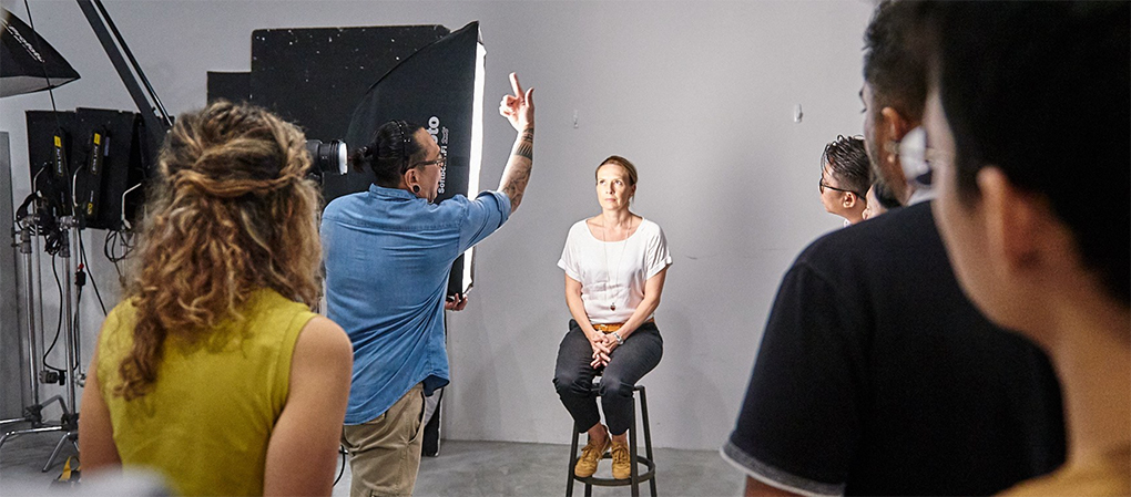 A Photographer Instructing A Model