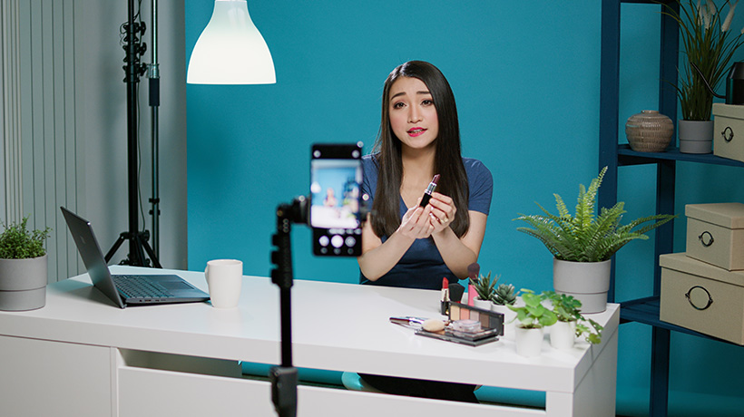 Woman filming short-form video content for TikTok or Reels.