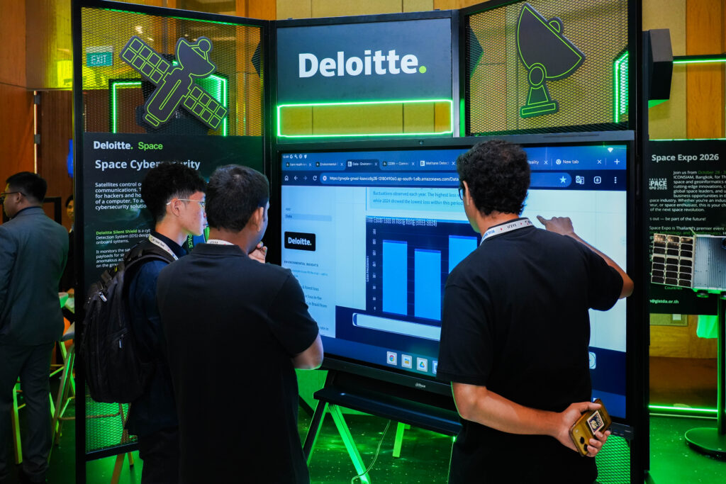 Interacting with live data analytics and space cybersecurity touchscreens at the Deloitte Space pavilion. 