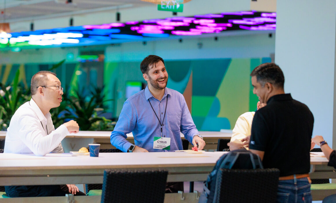 Three attendees networking at the Trascent Asia Pacific Conference, Grab Headquarters, One-North Singapore.